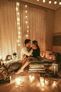 Two people on a candlelit date, illustrating the difference between genuine interest and love bombing in a new relationship.